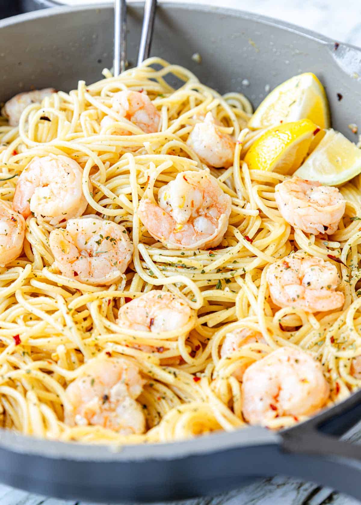 a skillet with white wine garlic shrimp pasta 