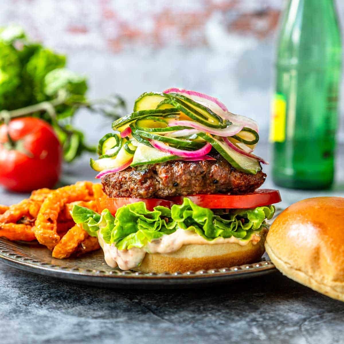 Pickled Cucumbers and Onions on top of a burger