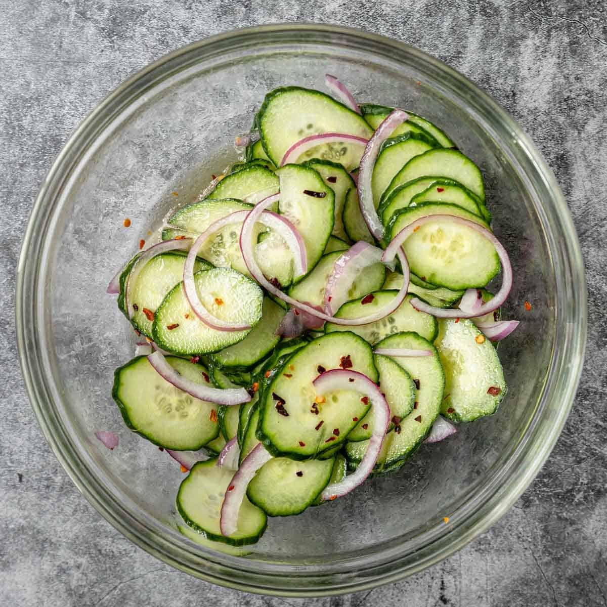 cucumbers and onions mixed together with a pickling liquid