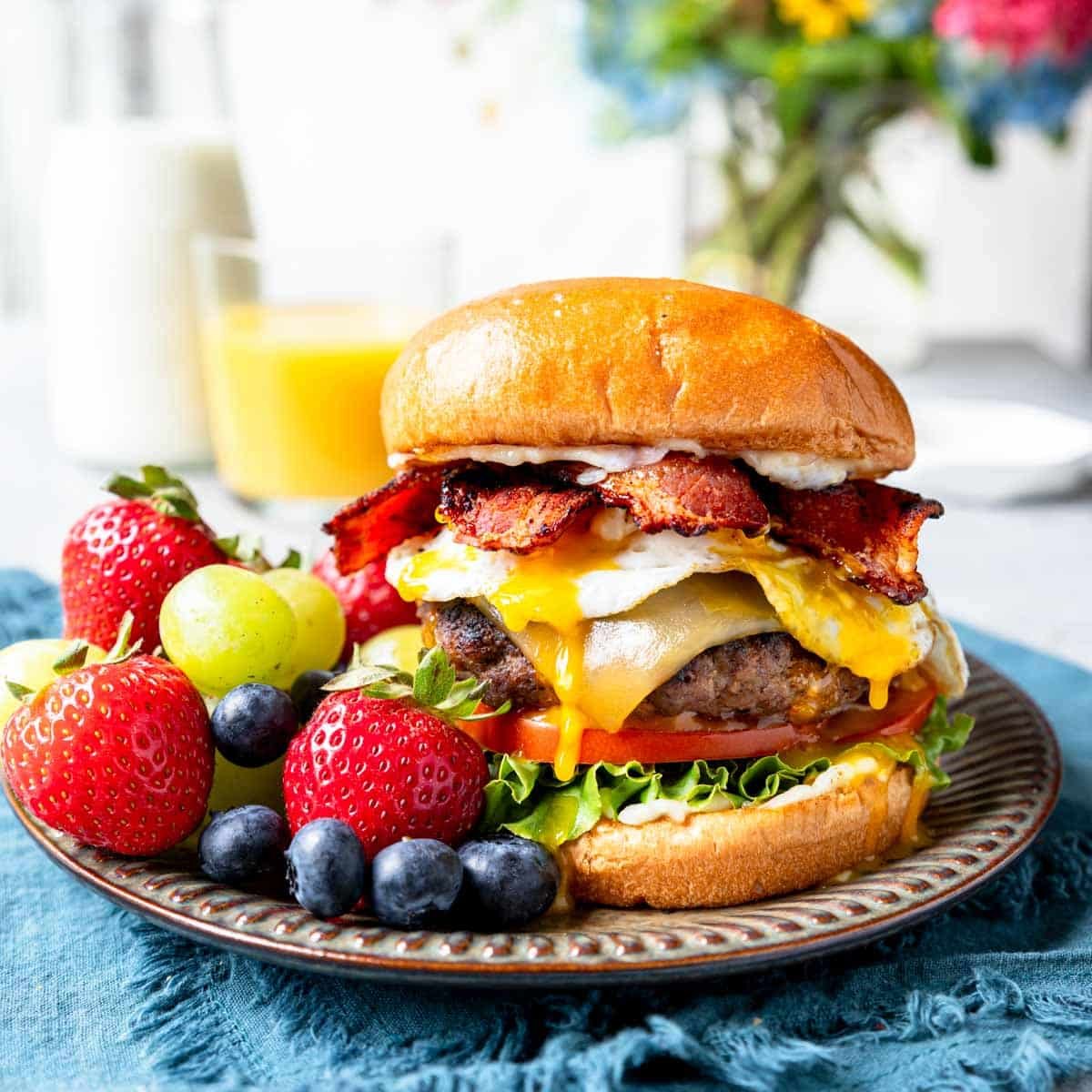 a brunch burger with lettuce, tomato, bacon, egg and garlic aioli