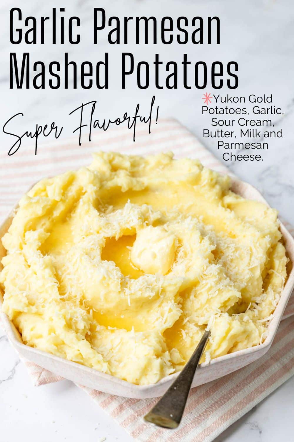 Pinterest pin for garlic parmesan mashed potatoes with a bowl of creamy potatoes topped with melted butter and more grated Parmesan.