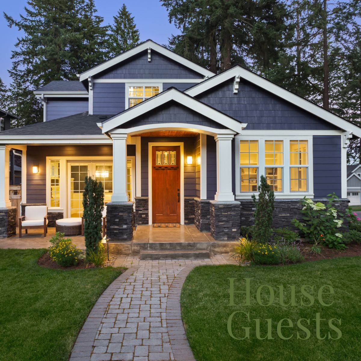 front of a house with lights on in the evening