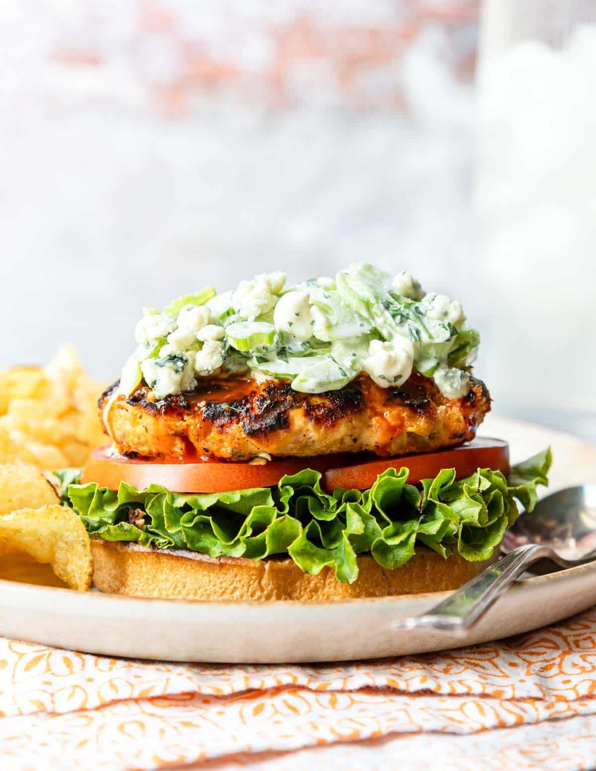 Celery slaw with blue cheese served over a buffalo burger.