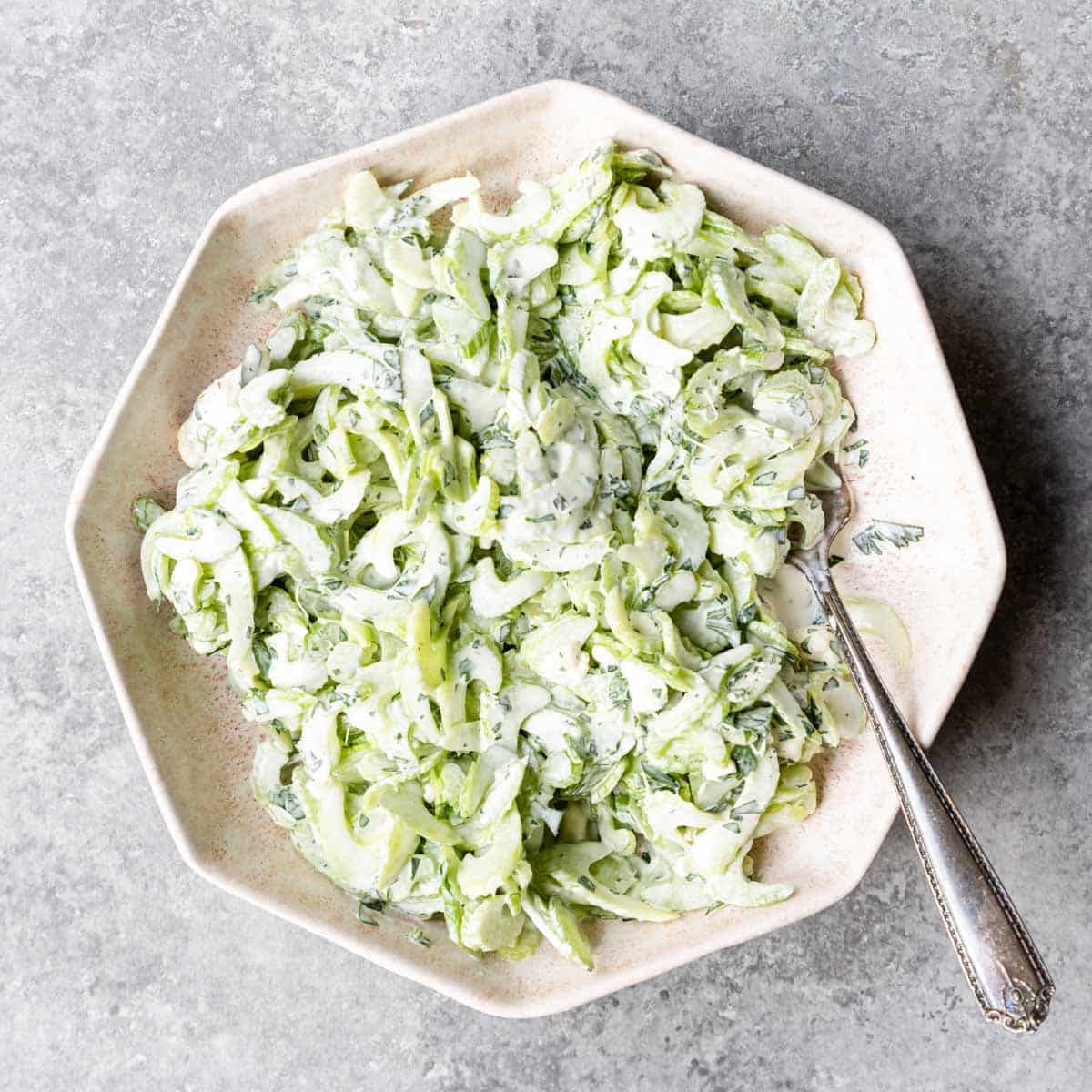 Top view of a bowlful of celery slaw with blue cheese.