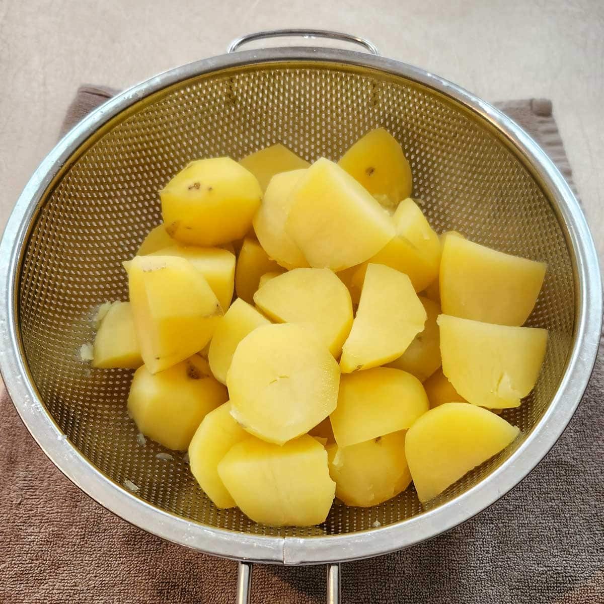 Boiled potatoes in a colander.