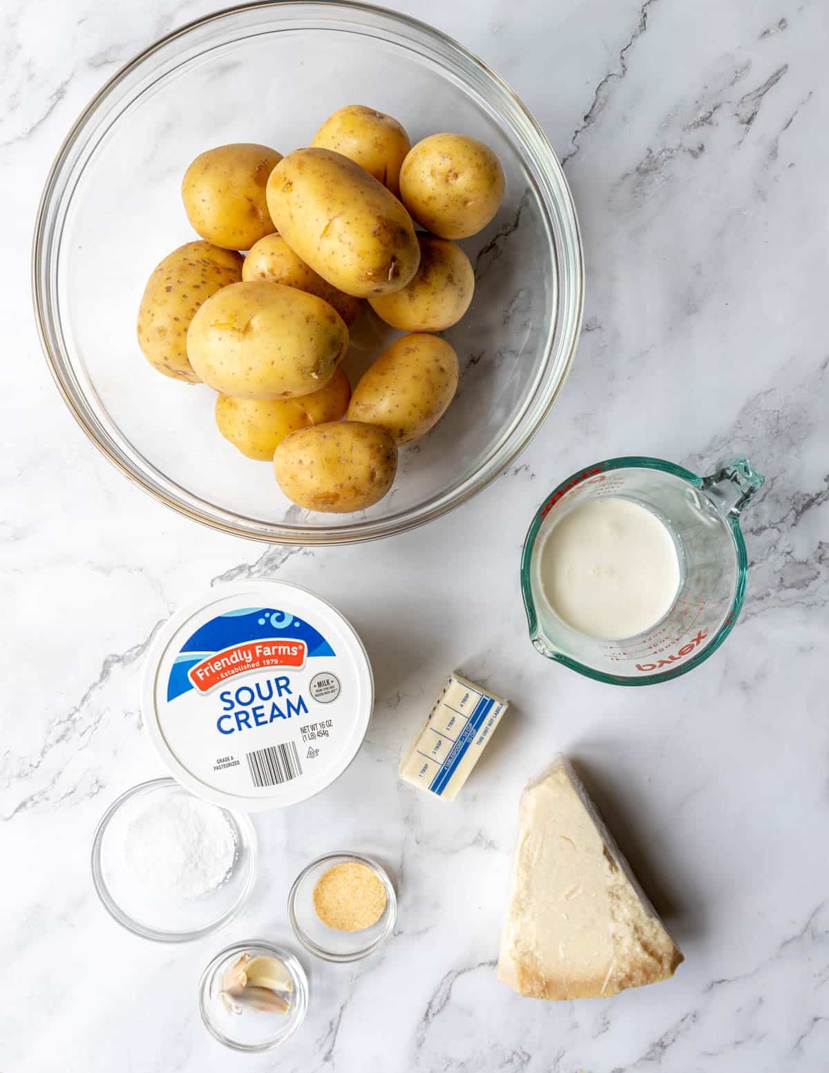 Ingredients shown are used to prepare garlic parmesan mashed potatoes.