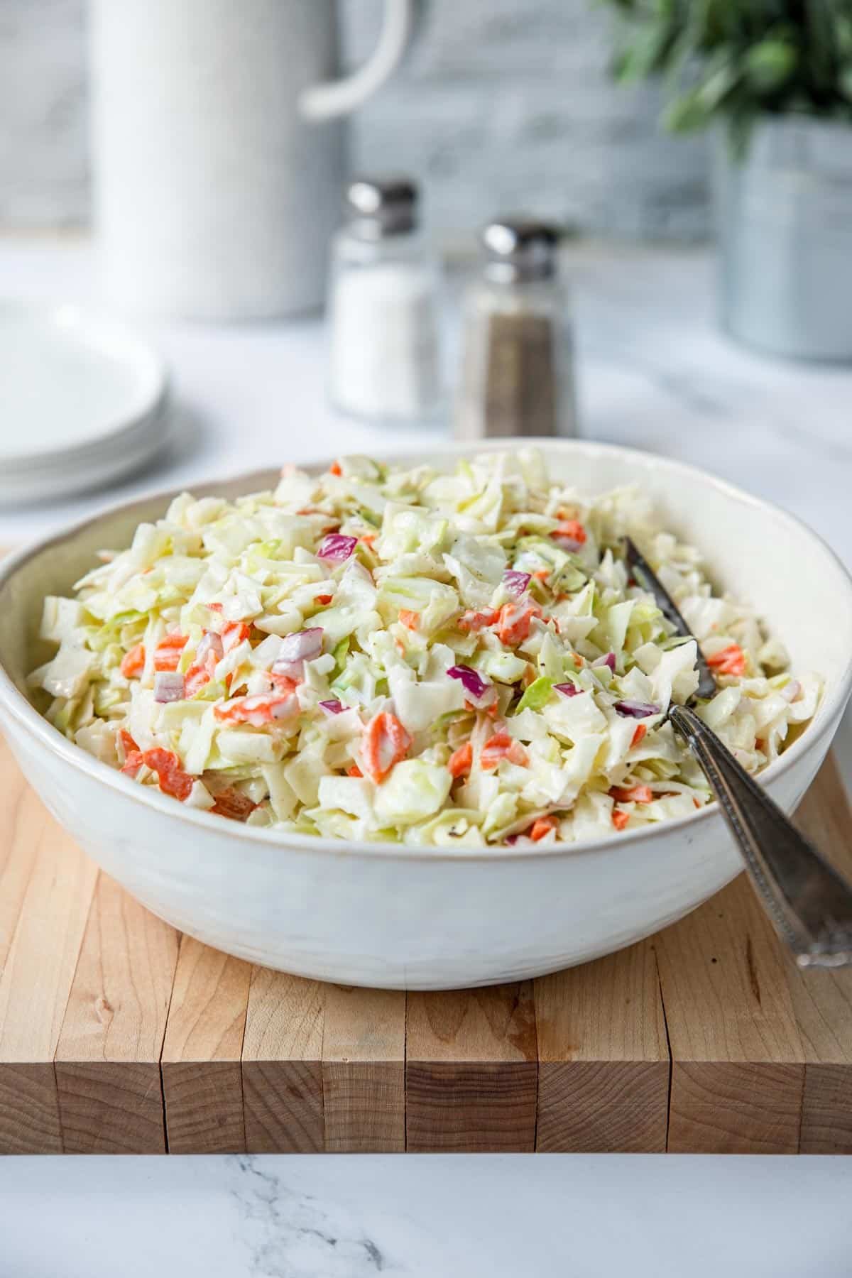 Serving bowl of creamy coleslaw.