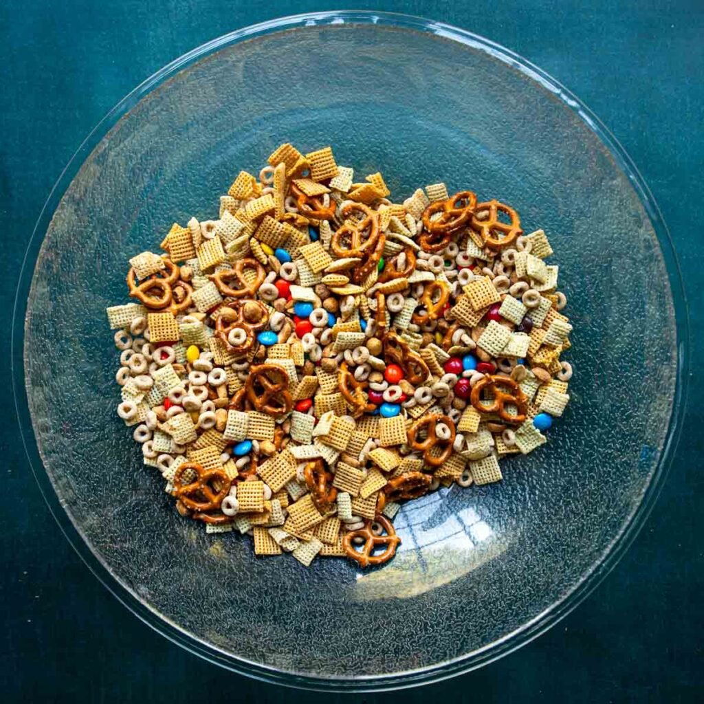 White chocolate chex mix dry ingredients combined in a mixing bowl.