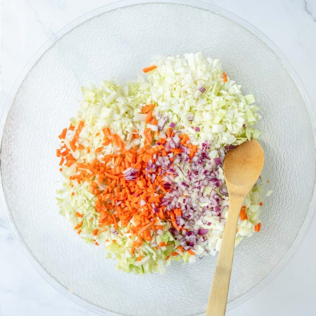 Chopped and diced ingredients added to a mixing bowl before combining.