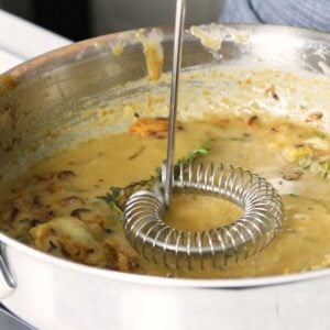 Whisk in a skillet to combine gravy ingredients with turkey base and stock.