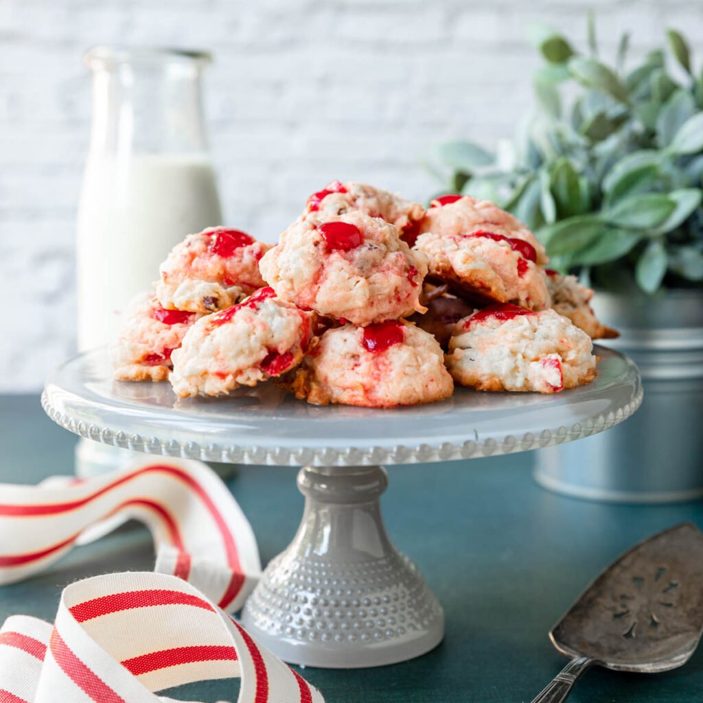 Cherry macaroons piled on a cake stand to enjoy.