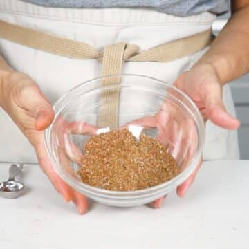 Hands holding a bowl of Homemade Taco Seasoning