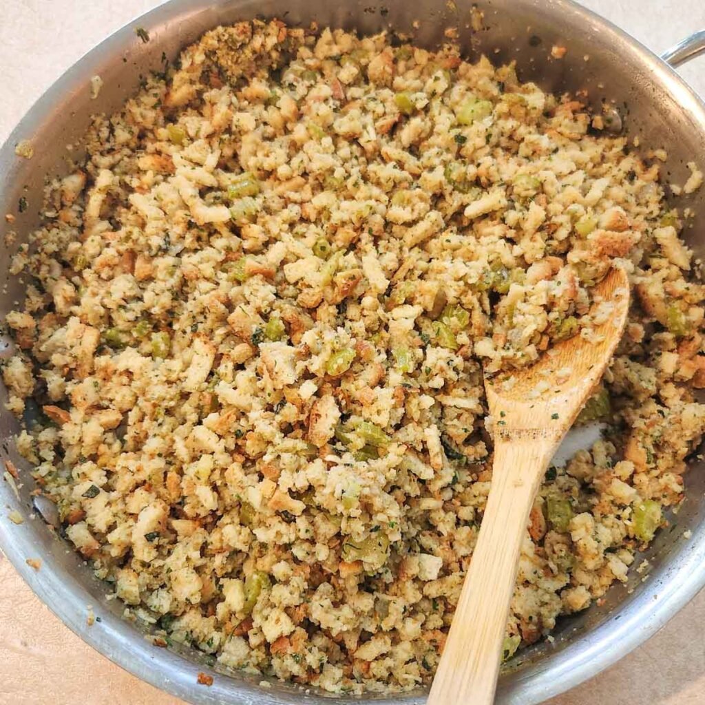 Wooden spoon resting in the stuffing mixture.