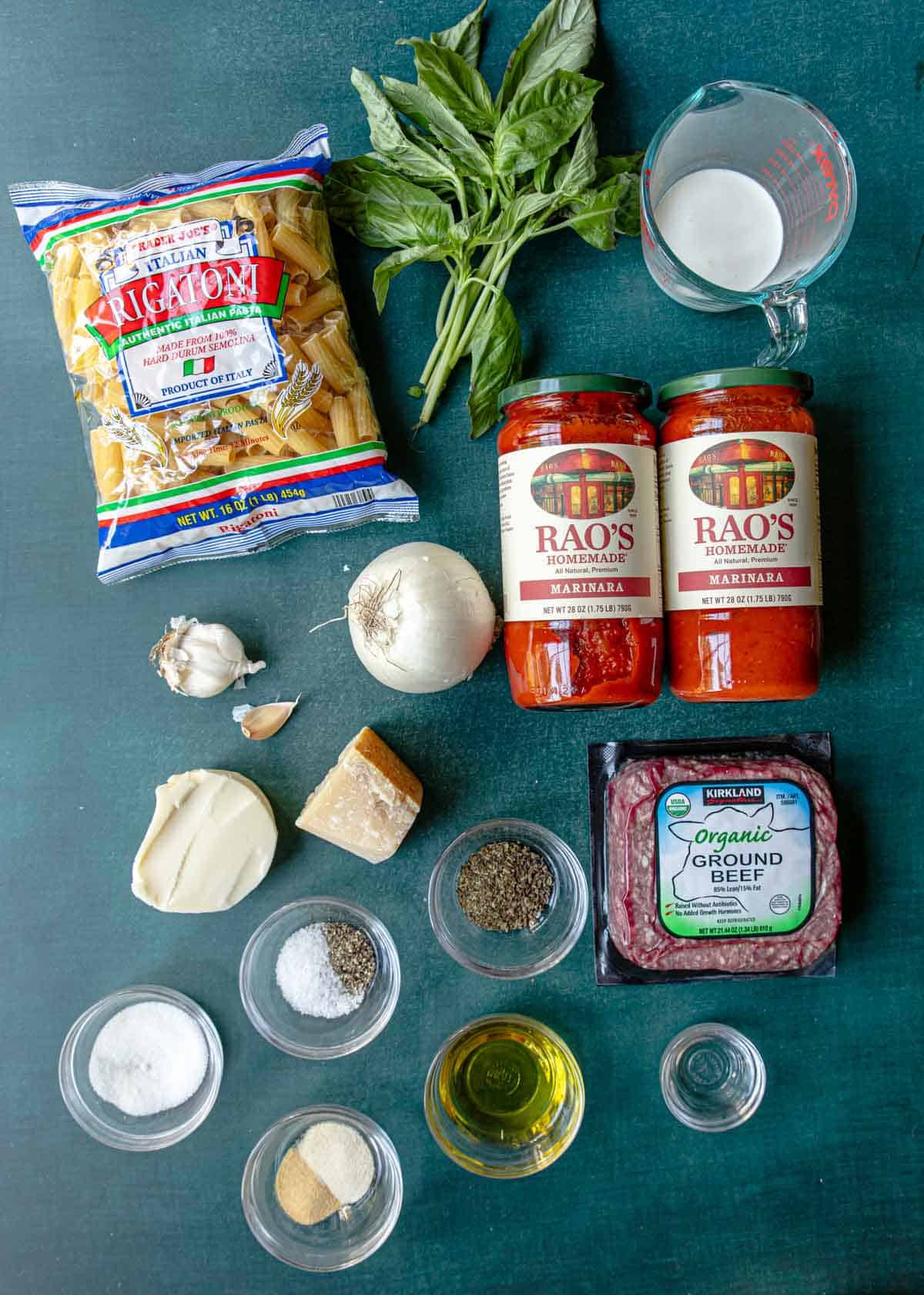 Ingredients shown are used to prepare baked rigatoni.