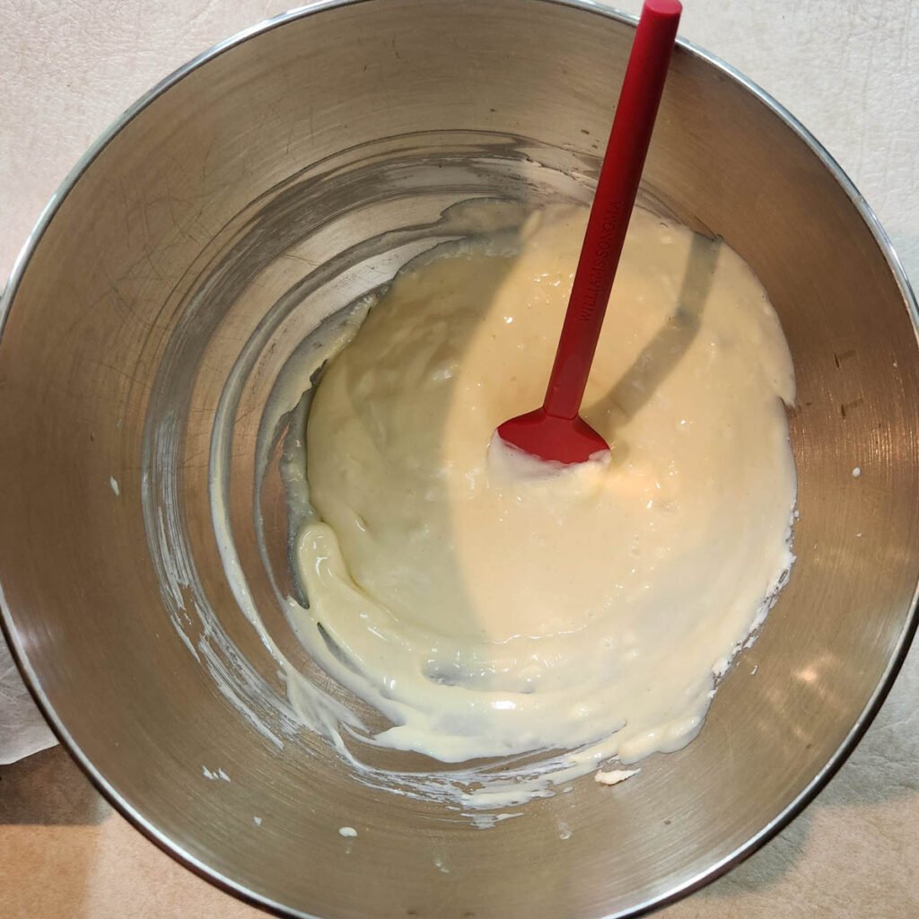 Cheesecake mixture in a mixing bowl.