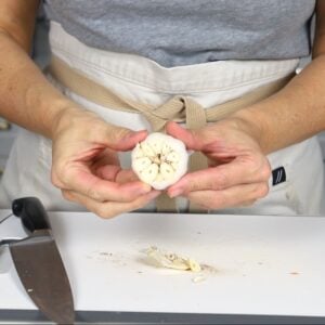 the top of a head of garlic cup exposing the individual cloves