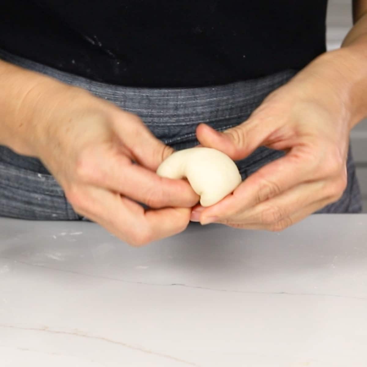 showing how to shape dinner rolls