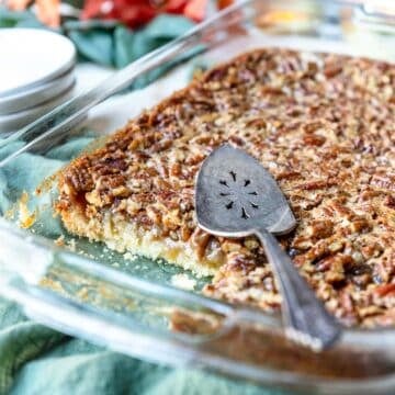 Pecan Pie Bars in a 9x13 pan with a few pieces cut