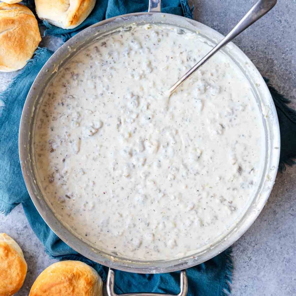 Top view of a skillet containing sausage gravy perfect for serving over biscuits for breakfast!