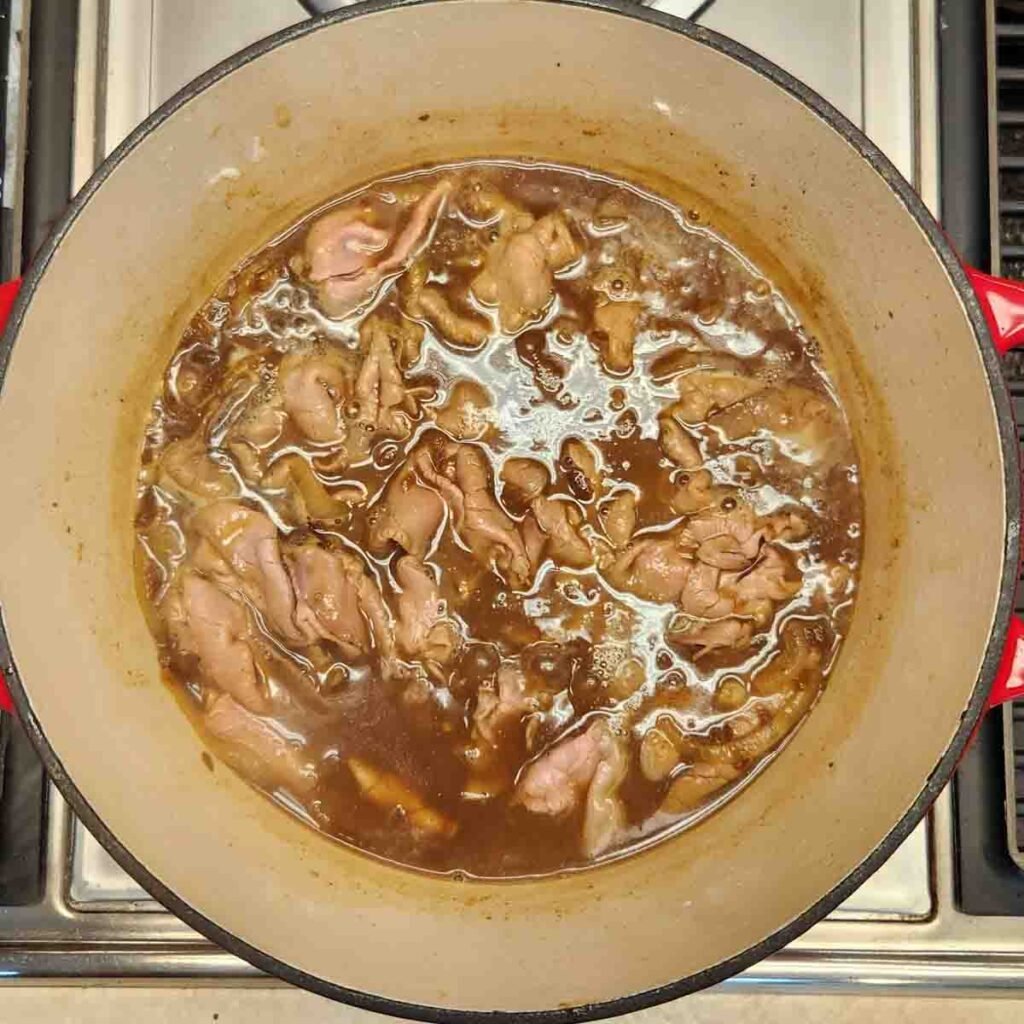 Au jus simmering in a Dutch oven.