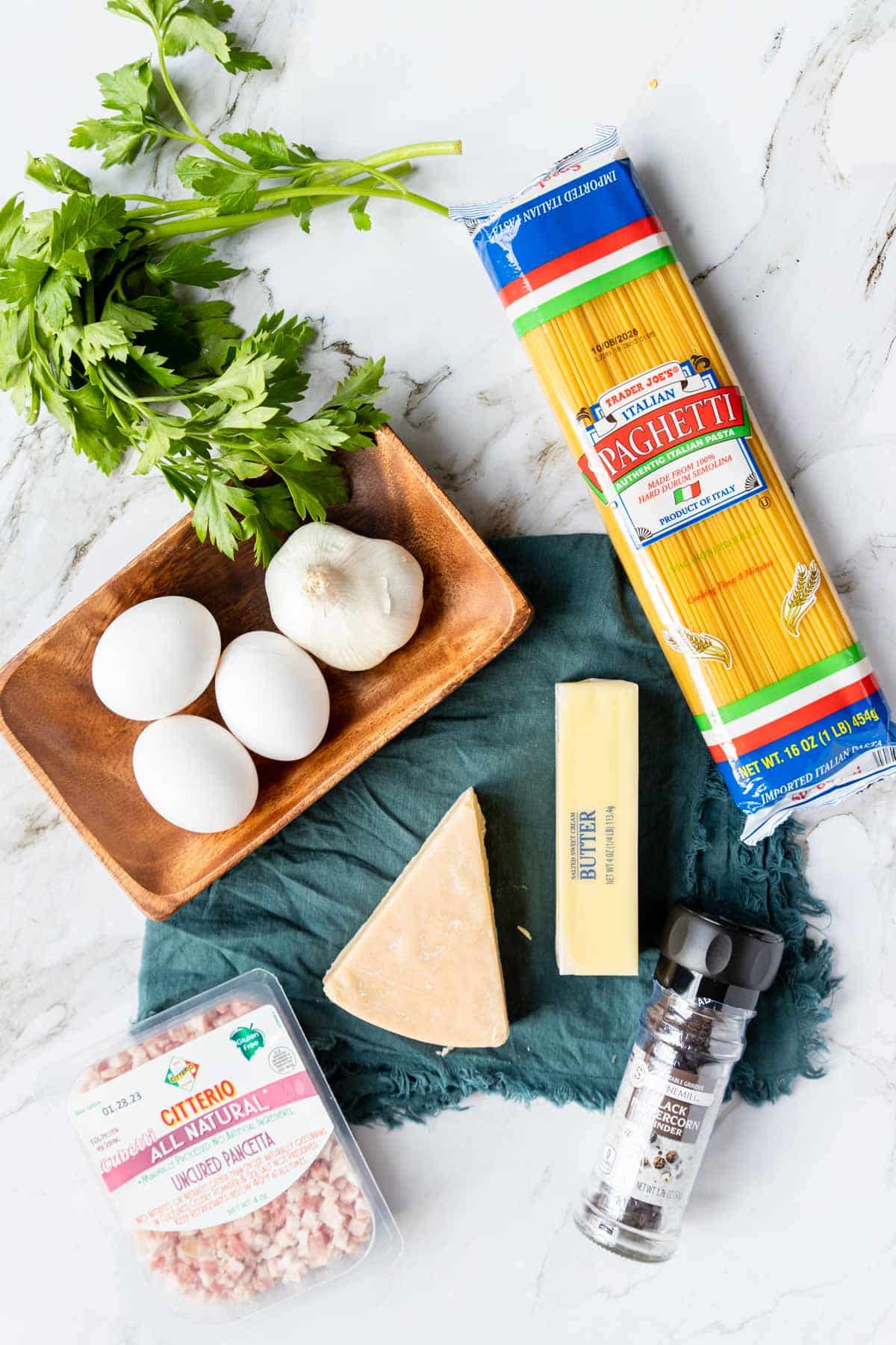 Ingredients shown are used to prepare Spaghetti Carbonara.