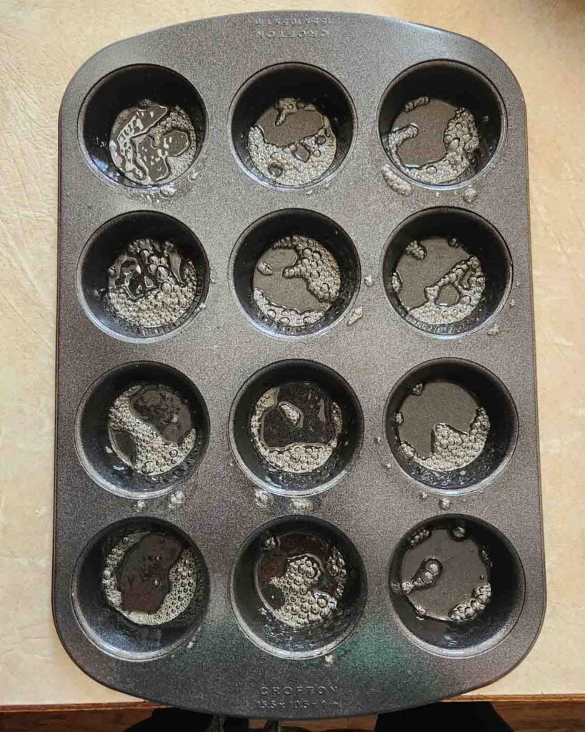 Muffin tin sprayed with cooking spray.