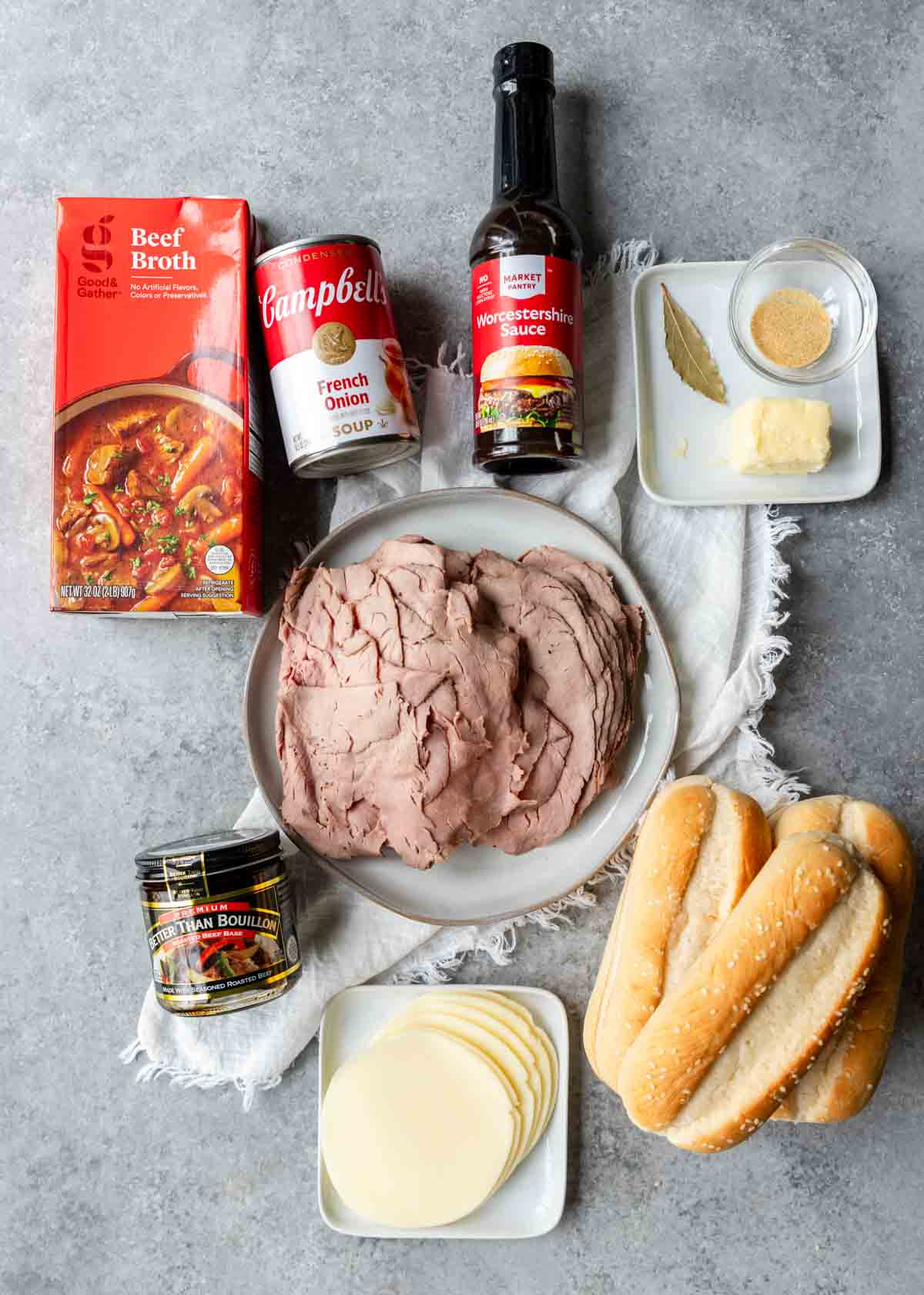 Ingredients shown are used to prepare French dip sandwiches with au jus.