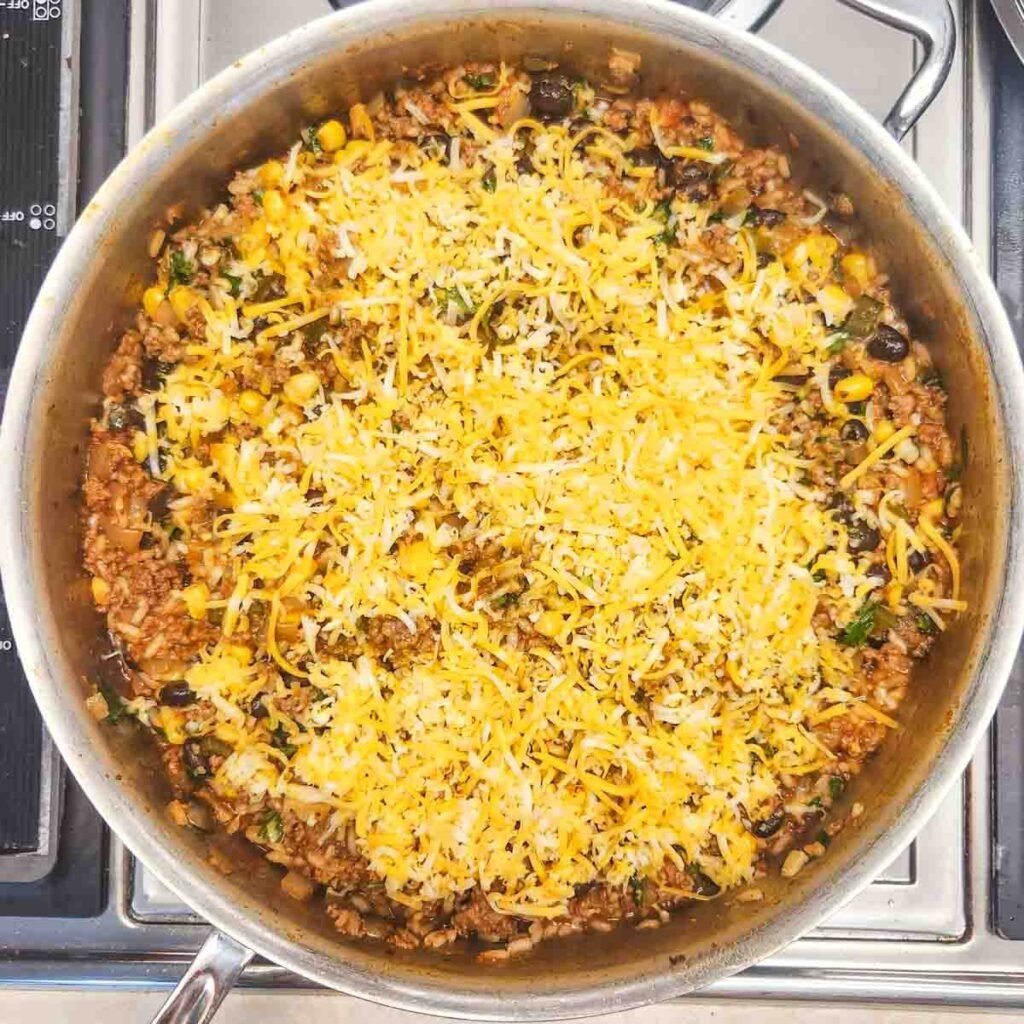 Cheese topping the taco skillet dinner, ready to melt.