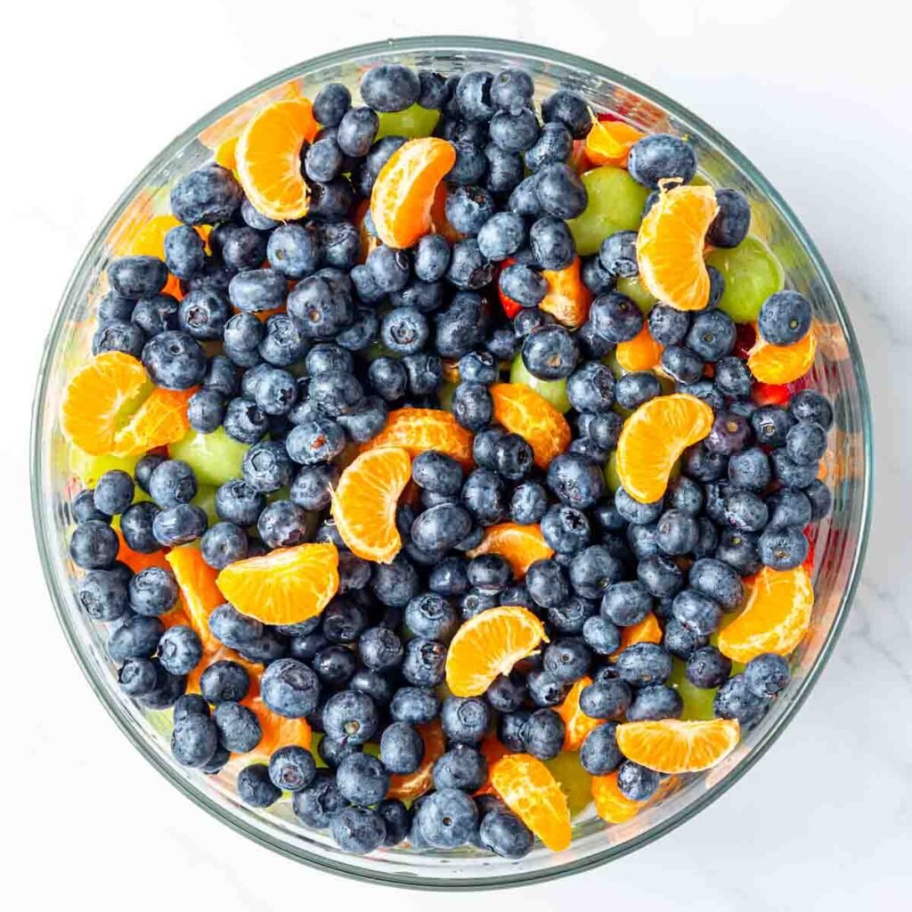 a top view of fruit salad layered in a bowl