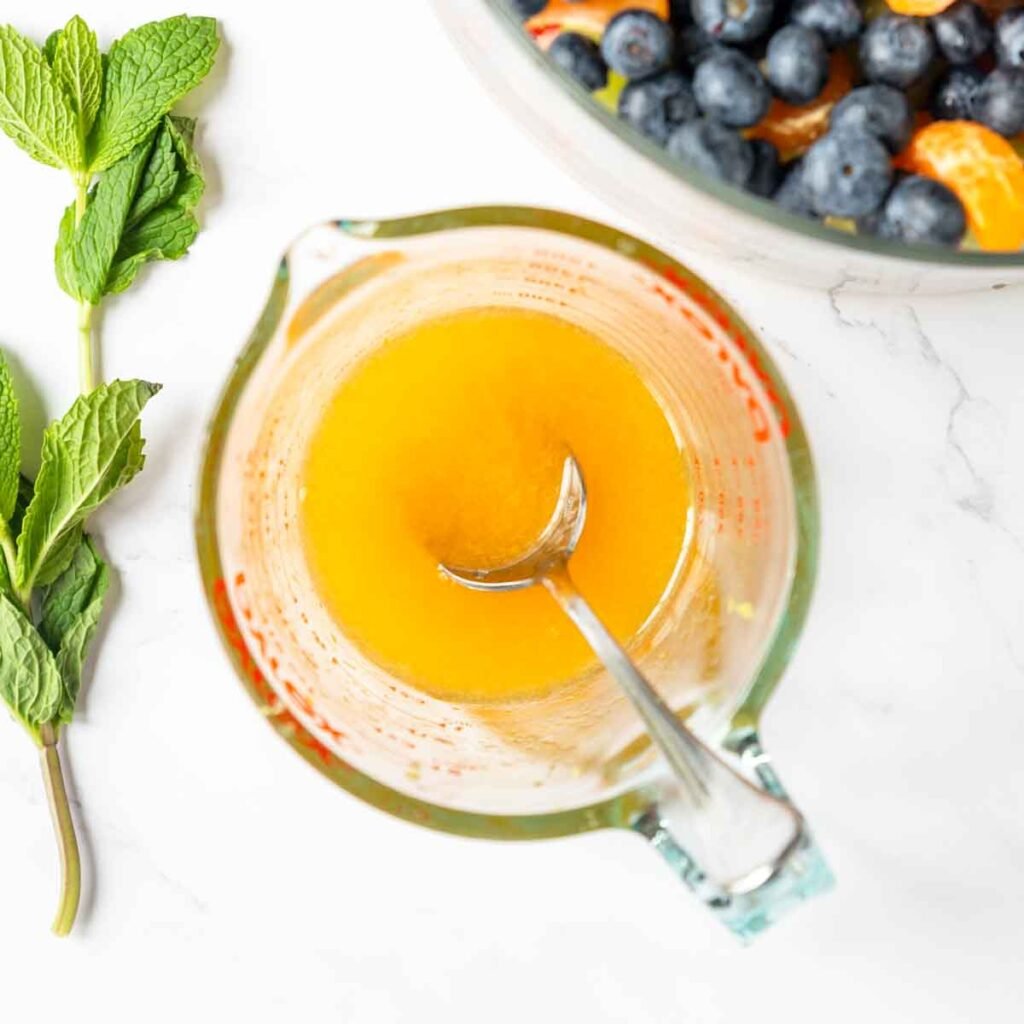 a glass measuring cup with a sugar citrus glaze