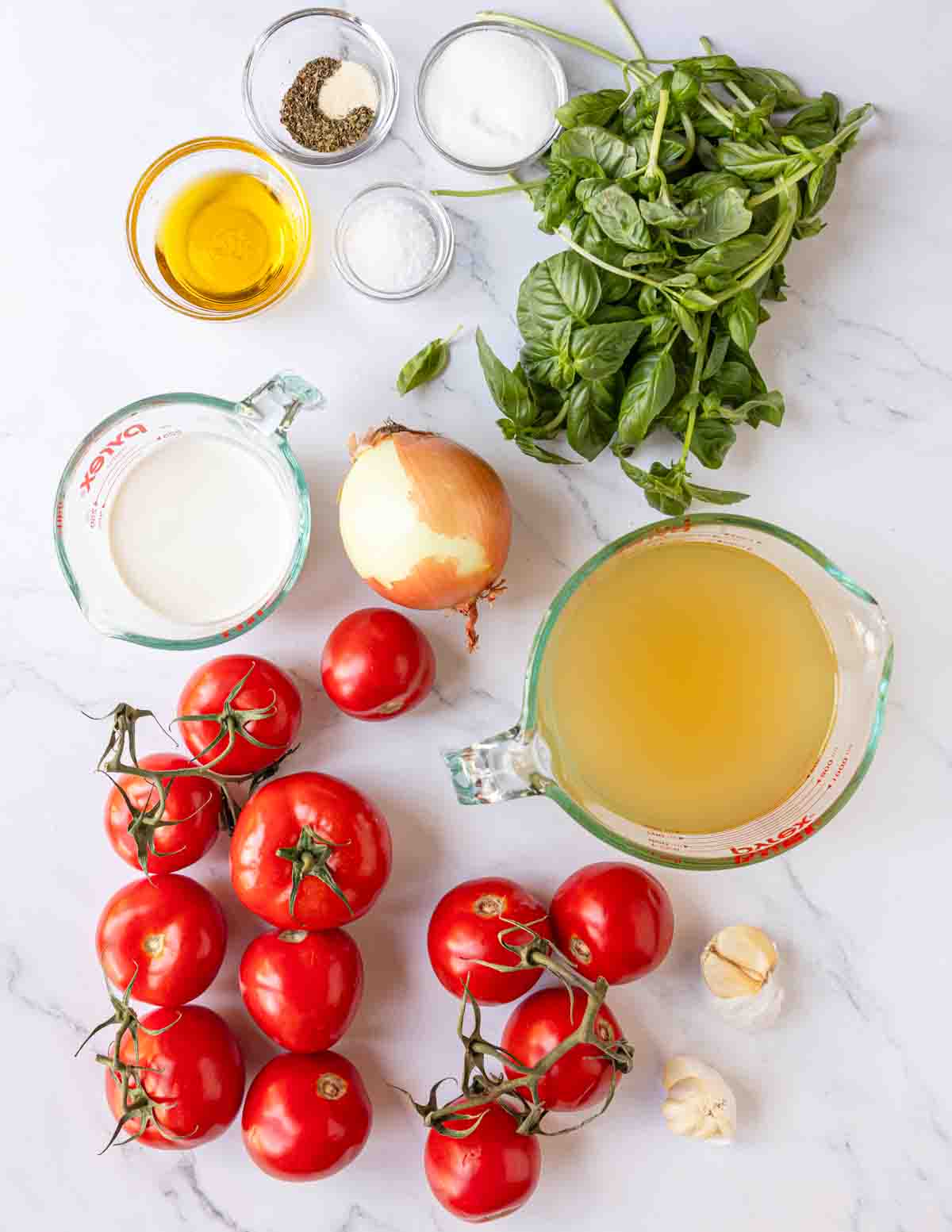 Ingredients shown are used to prepare roasted tomato basil soup.