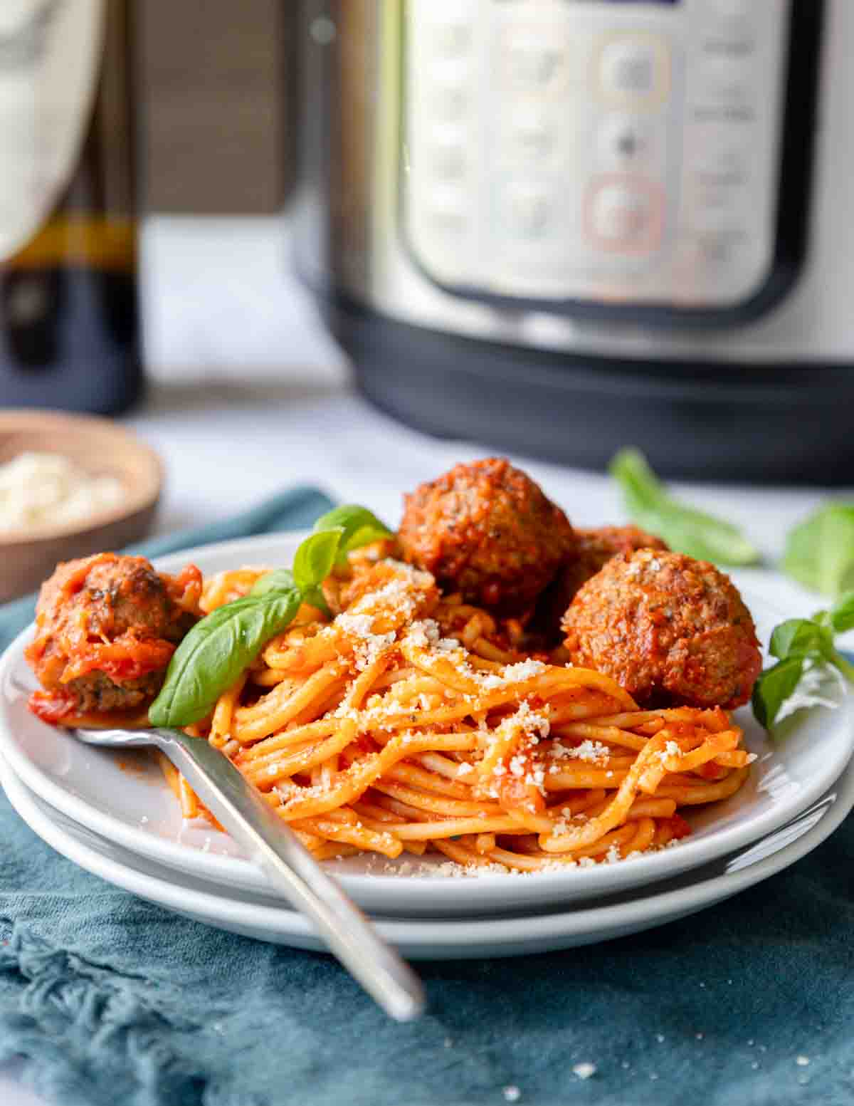 Spaghetti topped with meatballs on a plate.