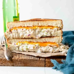 A tuna melt sandwich cut in half and stacked on top of eachother
