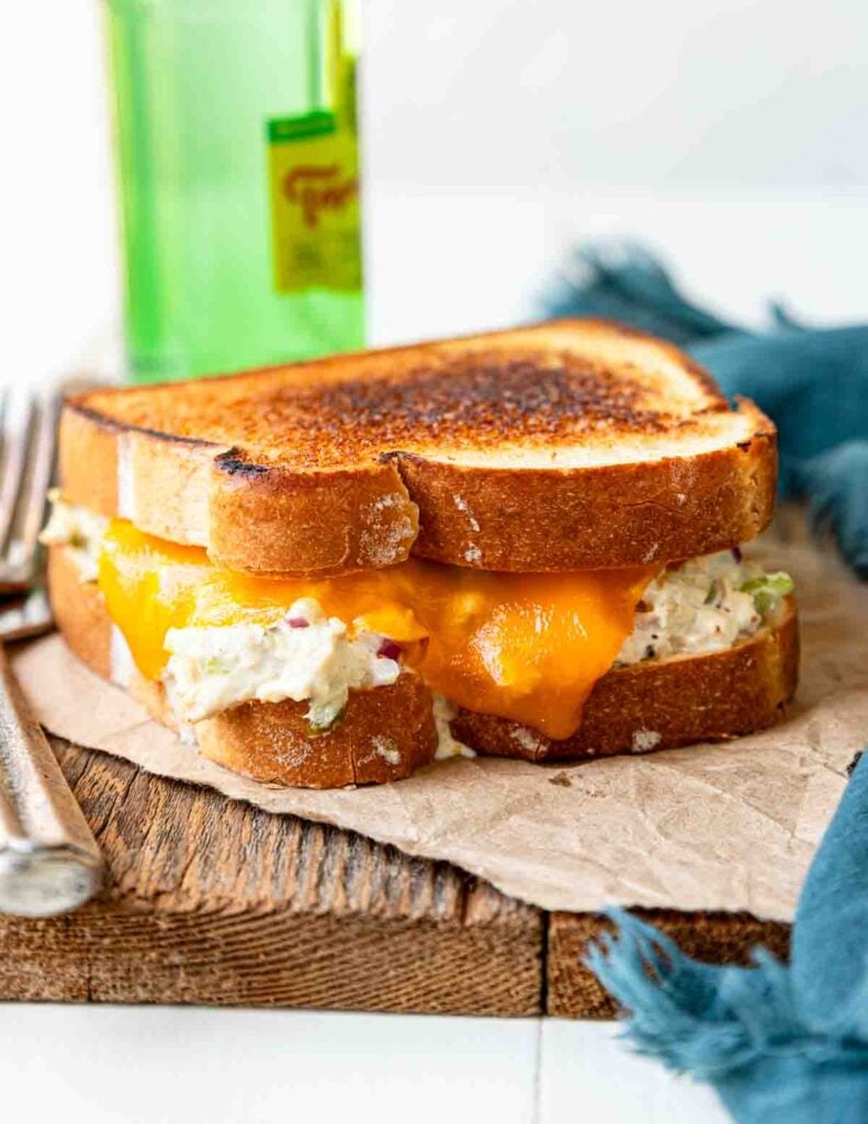 a toasted tuna melt sandwich on a cutting board