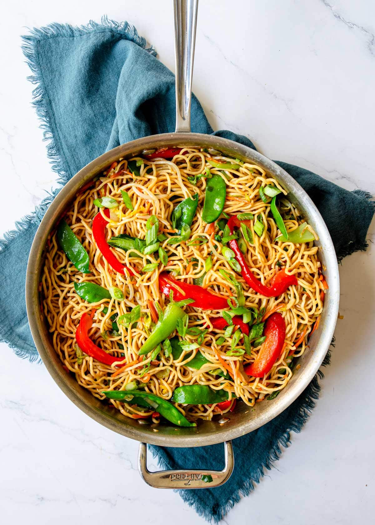 Veggie Lo Mein prepared on the stovetop in a skillet.