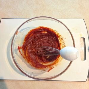 Chicken marinade being prepared in a mixing bowl.