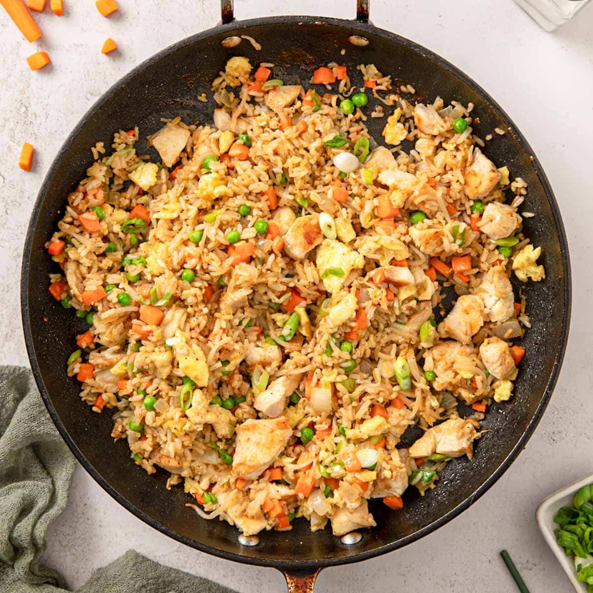Top view of a large wok filled with chicken fried rice ready to serve.