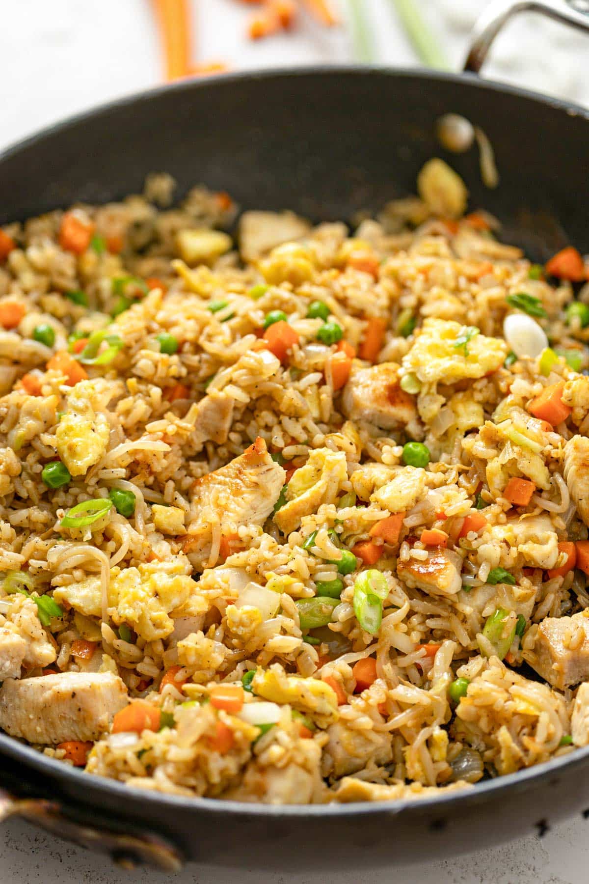 Chicken and vegetable fried rice in a wok.