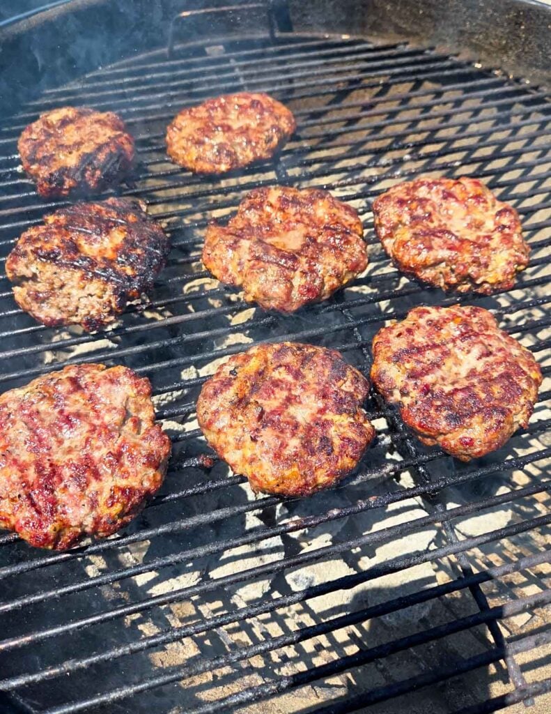 Ribeye Burgers grilling on a charcoal grill