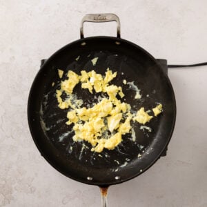 Scrambled eggs in a pan.