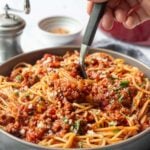 Pinterest image for Beef Bolognese with text overlay a picture of a bowl of spaghetti with sauce