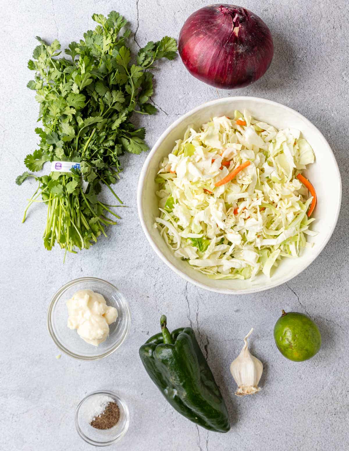 Ingredients shown are used to prepare coleslaw for fish tacos.
