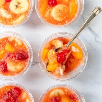 Frozen fruit cups with with a spoon