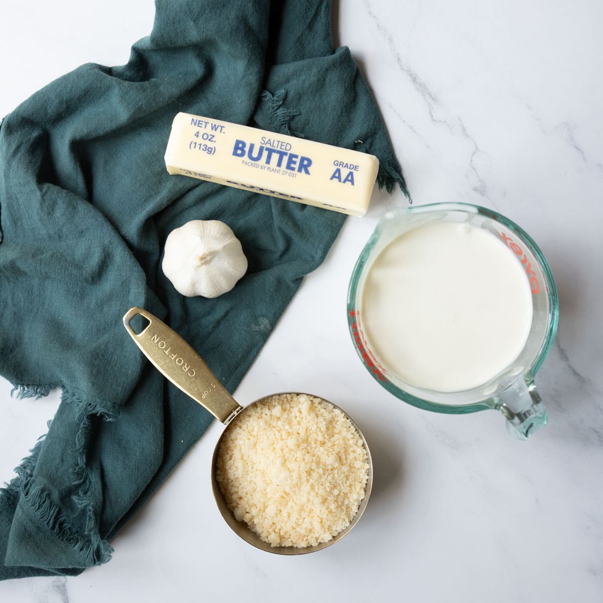 4 ingredients shown are used to prepare homemade alfredo.