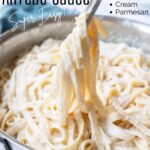 Fettuccine Alfredo being pulled out of a pan with text overlay for Pinterest
