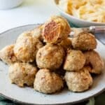 Stack of golden browned turkey meatballs on a plate.