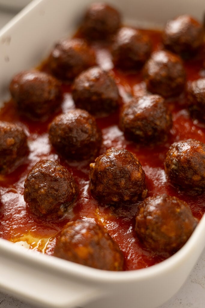 Glazed sweet and sour meatballs ready to serve in a baking dish.