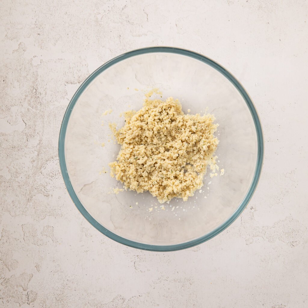 Breadcrumbs and milk in a glass bowl.