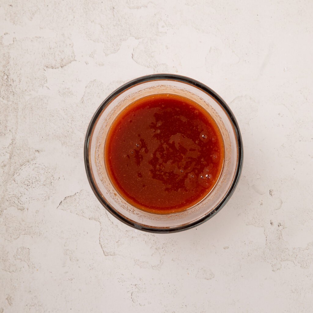 sweet and sour sauce in a small glass bowl.