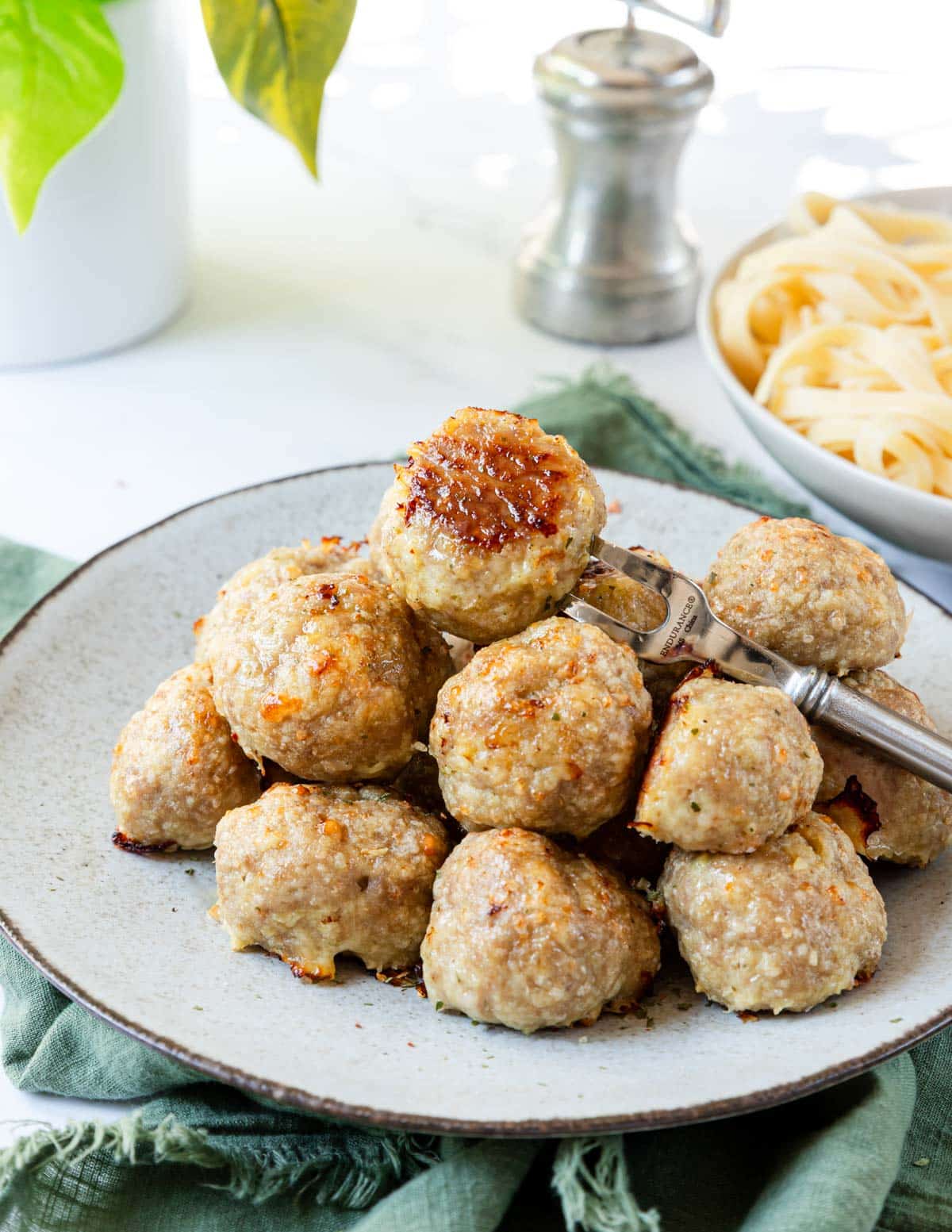 Turkey meatballs browned to perfection stacked on a plate.